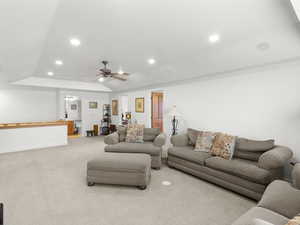 Carpeted living room featuring recessed lighting, visible vents, and a ceiling fan