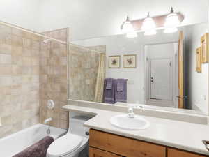 Full bathroom featuring shower / tub combo, toilet, and vanity