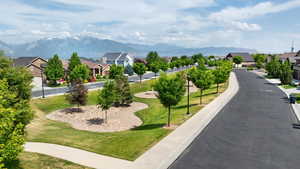 View of home's community featuring a residential view, a mountain view, and a yard