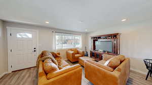 Living room featuring recessed lighting, light wood-type flooring, and baseboards
