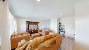 Living room featuring visible vents, recessed lighting, and light wood-style floors