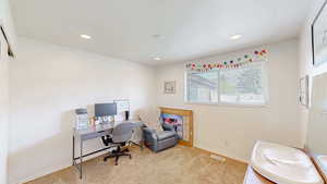 Office area featuring visible vents, recessed lighting, and carpet