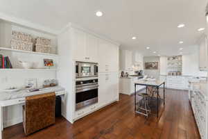 Kitchen featuring crown molding, dark wood finished floors, white cabinetry, open shelves, and stainless steel appliances
