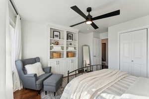 Bedroom featuring dark wood-style floors, a closet, and ceiling fan