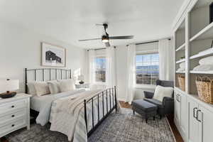 Bedroom with baseboards, a ceiling fan, and dark wood finished floors