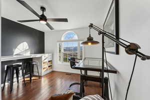 Office with ceiling fan, baseboards, visible vents, and hardwood / wood-style flooring