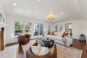 Living area featuring ornamental molding and recessed lighting