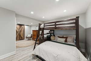 Bedroom with recessed lighting, baseboards, and wood finished floors