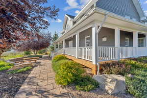 View of side of property featuring covered porch