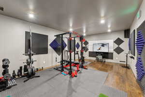 Workout room with visible vents, baseboards, and wood finished floors