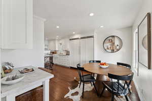 Dining area featuring recessed lighting, dark wood-style flooring, and ornamental molding