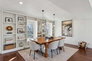 Dining space featuring hardwood / wood-style flooring, visible vents, baseboards, and ornamental molding