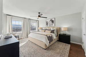 Bedroom with wood finished floors, baseboards, and a ceiling fan