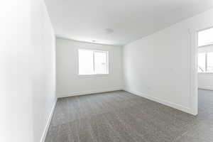 Unfurnished room featuring carpet floors and baseboards