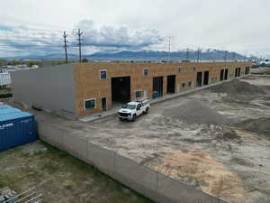 Rear view of house featuring fence and a mountain view