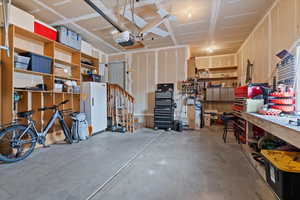 Garage with a workshop area and a garage door opener