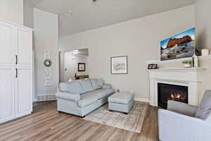Living area featuring corner gas log fireplace,  LVP flooring