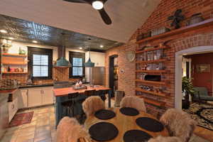 Kitchen featuring custom range hood, white cabinetry, a ceiling fan, open shelves, and wooden counters