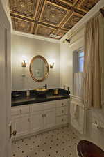 Bathroom with vanity, an ornate ceiling, and ornamental molding