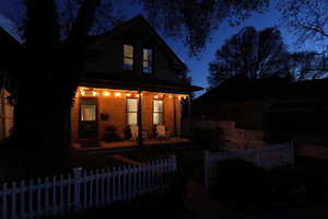 Exquisite home featuring covered porch and a fenced front yard