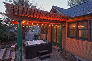 View of patio featuring a pergola, fence, and a hot tub
