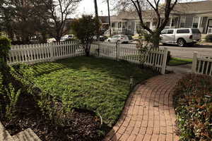 View of front yard featuring fence