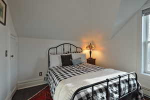 Bedroom with window, and vaulted ceiling