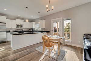 Dining space featuring light wood-style flooring, baseboards, and recessed lighting