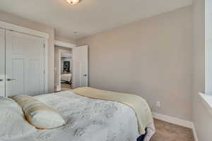 Carpeted bedroom featuring baseboards