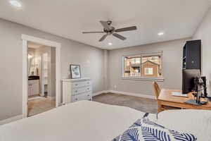 Bedroom featuring ensuite bathroom, baseboards, a ceiling fan, and recessed lighting
