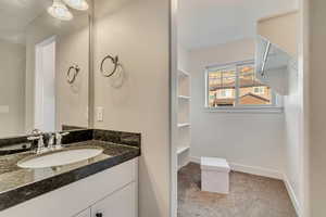 Bathroom with vanity and baseboards