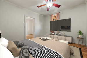 Bedroom featuring baseboards, crown molding, a ceiling fan, and wood finished floors
