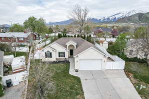 Ranch-style home with stucco siding, a gate, driveway, a garage, and fence