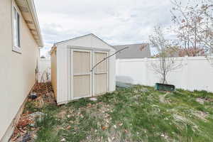 View of shed featuring a fenced backyard