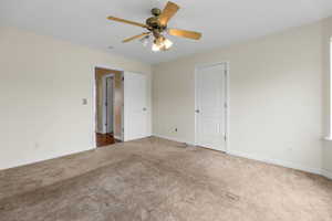 Unfurnished bedroom featuring baseboards, a ceiling fan, and carpet floors