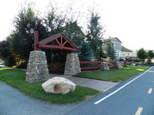 View of property's community with a lawn