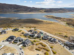 Aerial view of property and surrounding area with nearby suburban area and a water and mountain view