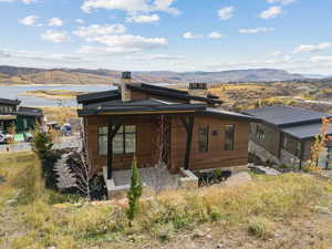 Back of property with a chimney and a mountain view