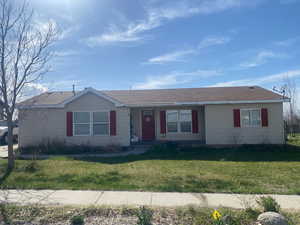 Ranch-style home with a front lawn