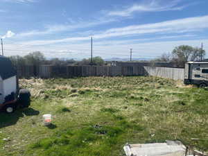 View of yard featuring fence