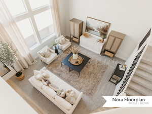 Living room with baseboards, stairway, and a high ceiling