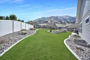View of yard with a mountain view and fence private yard