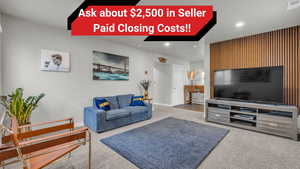 Living area featuring carpet flooring, recessed lighting, and baseboards