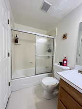 Full bath with enclosed tub / shower combo, and vanity.