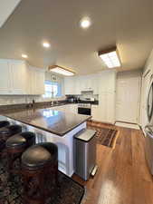 Updated kitchen with granite countertops, peninsula, stainless steel appliances and hardwood flooring.