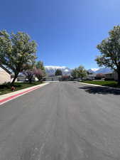 View of road with a mountain view, sidewalks, and curbs
