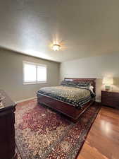 Bedroom featuring hardwood flooring, and en suite.