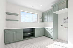 Clothes washing area with electric dryer hookup, washer hookup, visible vents, cabinet space, and light floors
