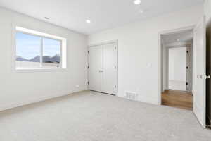 Unfurnished bedroom with recessed lighting, baseboards, visible vents, and carpet floors