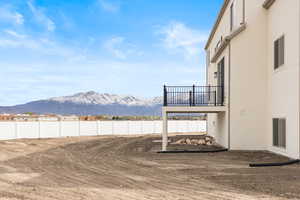 View of yard with fence and a mountain view